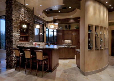 Central kitchen With Feature Stone Wall & Curved Partition With Shelving.