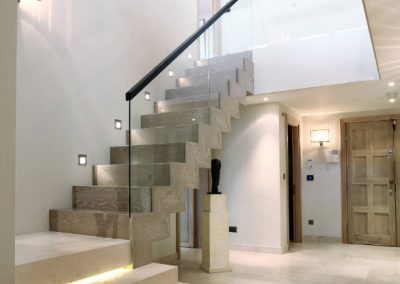 Contemporary Staircase with Lighting, Stone & Wood.
